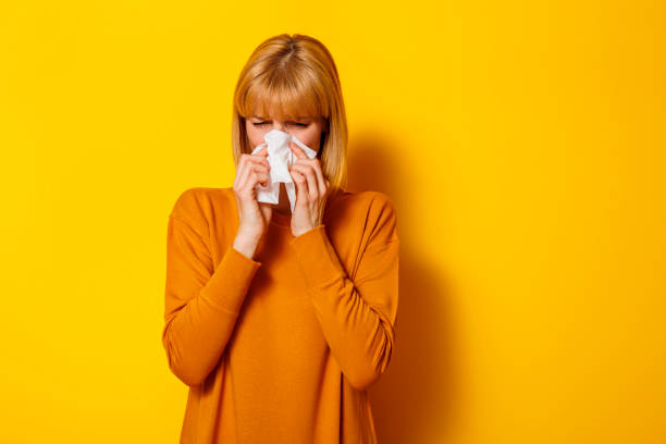 istock Sick woman blowing nose while having flu 1598422952