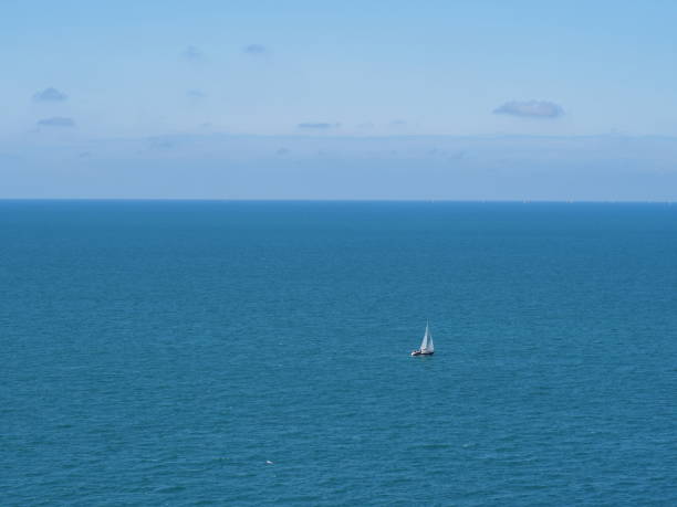 There is a sailboat in the sea connected to the sky