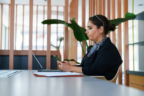 istock Businesswoman using mobile phone at the office 1598425753
