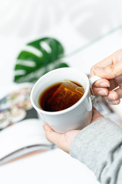istock Hand holding cup of herbal tea 1598442223