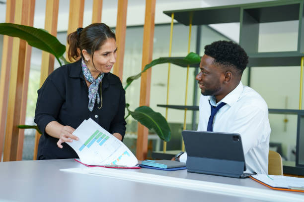 istock Diverse people working  on financial paperworks at the office 1598443477