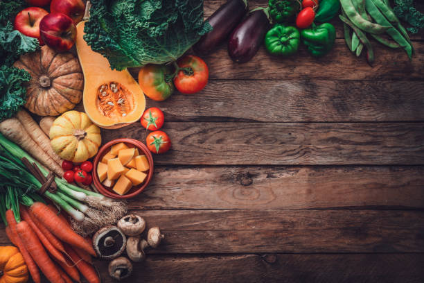 istock Fresh organic autumnal vegetables border. Copy space on wooden table 1598445236
