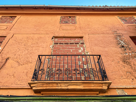 Low angle view of blocked balcony window in abandoned house to prevent trespassing in the city of Valencia, Spain