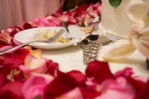 An Eaten wedding cake on a plate at a wedding reception