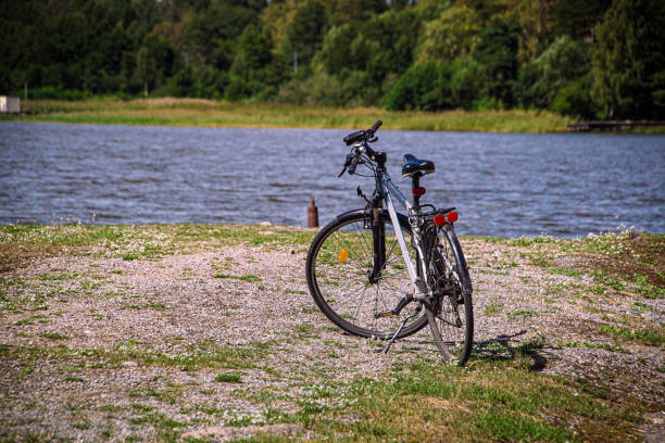 istock a bicycle stands on the sandy beach 1598477396