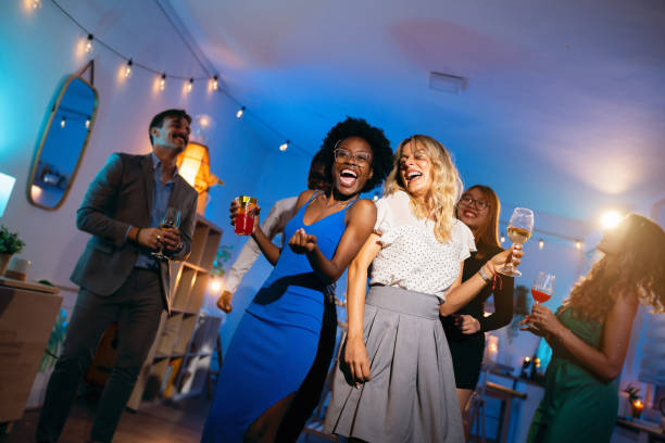 istock Group of multiracial people dancing during a house party 1598481852