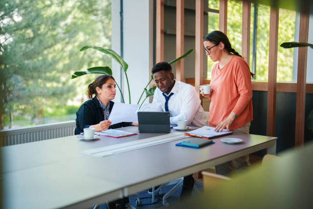 istock Woman presenting her reports with her coworkers 1598488995
