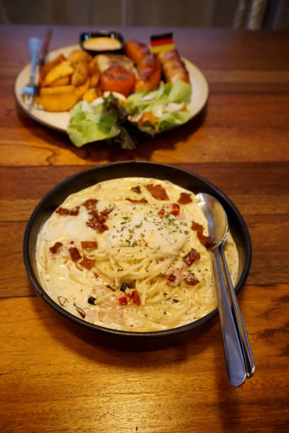 istock Spaghetti carbonara with becon on wooden table 1598498334