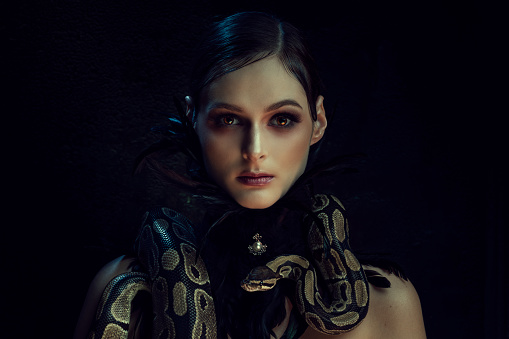 Portrait of beautiful woman with snake