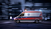 Ambulance car, 911 emergency medical service in the night city street, blurred motion shot