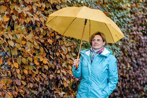Mature woman enjoying a rainy day on Lake Bled in SLovenia