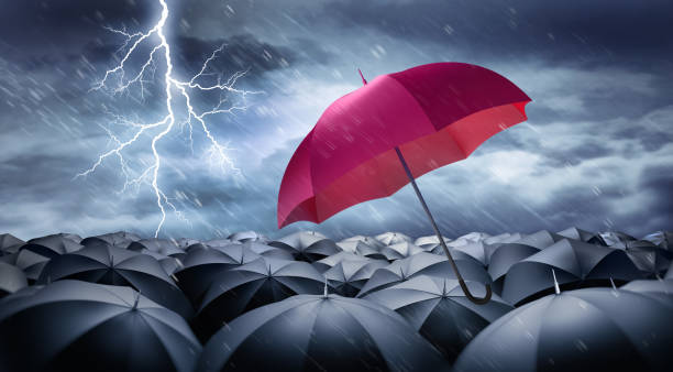 istock Umbrellas in heavy weather with lightning 1598542270