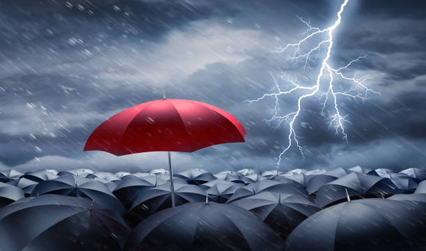 istock Umbrellas in heavy weather with lightning 1598542354