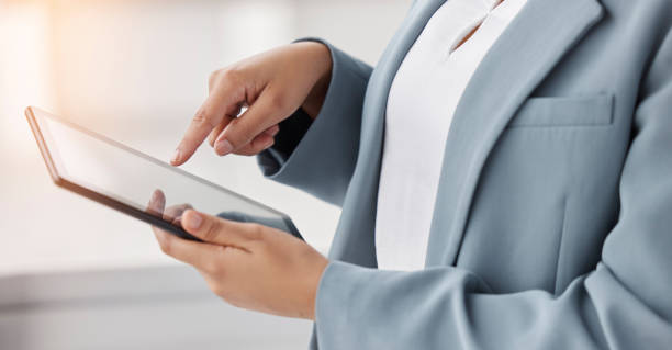 istock Hands, typing and a person with a tablet at work for communication, email or internet research. Closeup, business and an employee with technology for analysis, website or working online in an office 1598550511