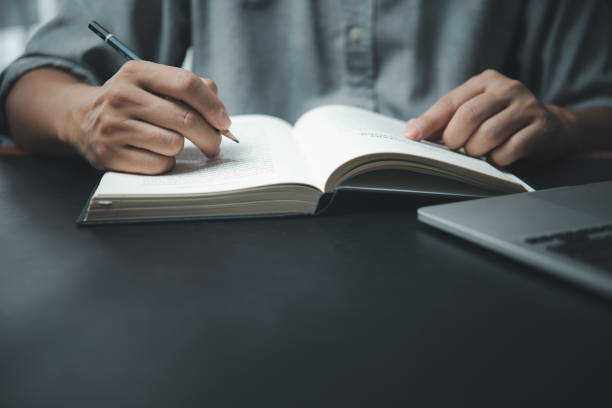 istock man hands with pen writing on notebook in the office.learning, education and work.writes goals, plans, make to do and wish list on desk. 1598559693