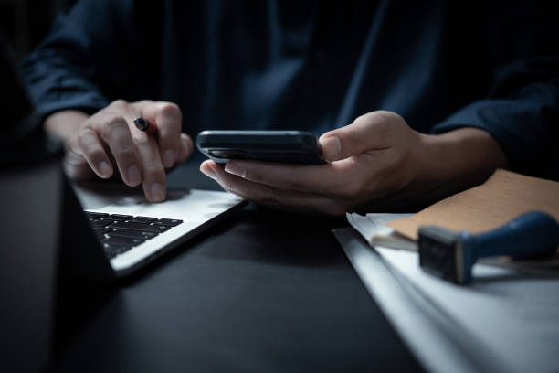 istock Business man using mobile smart phone management information financial documents, marketing online, job and payment digital technology on desk. 1598559696