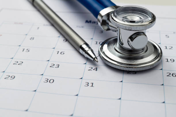 istock Stethoscope and pen on a calendar 1598563582