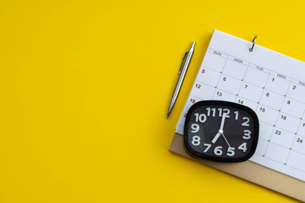 istock Calendar and alarm clock on yellow background 1598568480