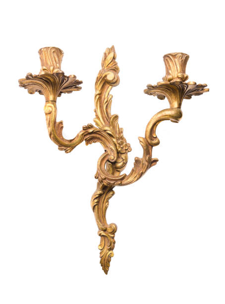 Antique gold candlestick on the wall on a white background.