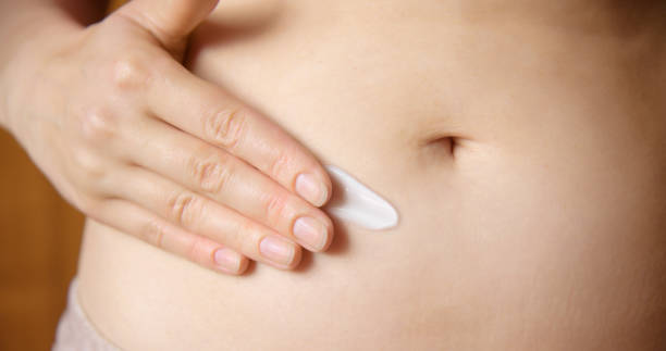 istock Gilrl applies cream on her body 1598575321
