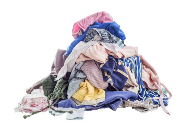 istock Used clothes in a pile. Sorting and cleaning second-hand. Preparing for washing. Copy space on white background 1598578918