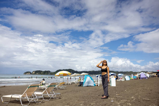 Beautiful woman standing on summer beach