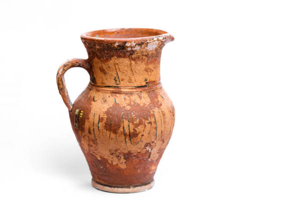 istock Antique earthenware jug with damaged paint on the surface. 1598604415