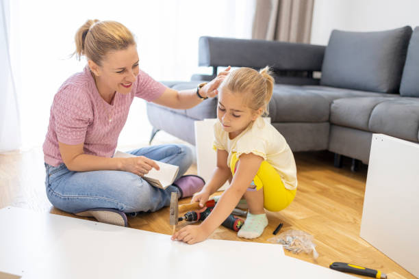 istock Woman looking at daughter hammering a nail 1598605786