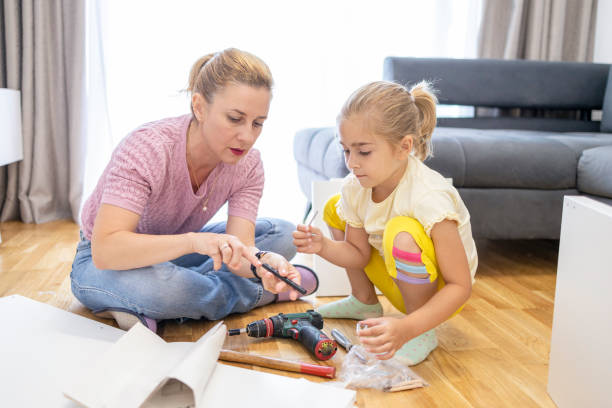 istock Mother and dughter learning how to use a drill 1598606353