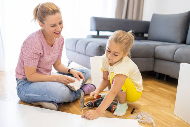 istock Girl learning how to use hammer at home 1598606887