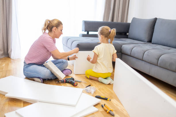 istock Girl learning how to use hammer at home 1598608061