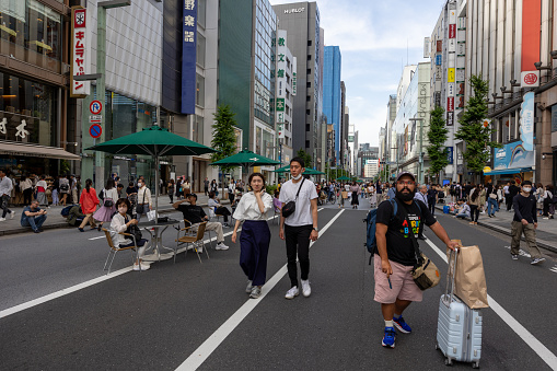Tokyo, Japan - May 27, 2023 : People at the Ginza’s Pedestrian Paradise in Tokyo, Japan. Ginza’s pedestrian paradise was started in September 1970 and is the oldest pedestrian paradise in Tokyo.