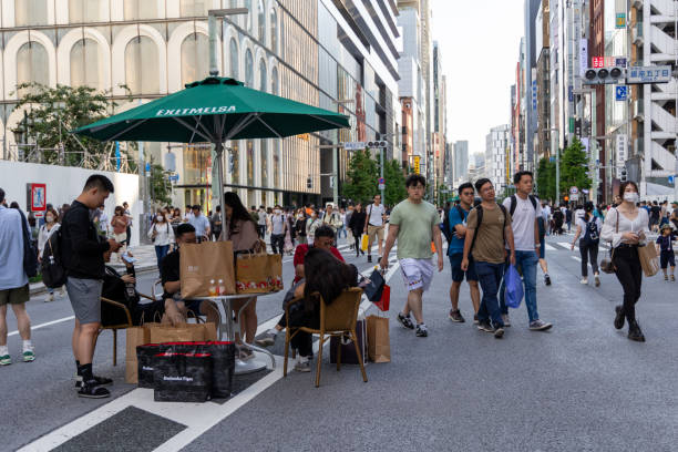 Tokyo, Japan - May 27, 2023 : People at the Ginza’s Pedestrian Paradise in Tokyo, Japan. Ginza’s pedestrian paradise was started in September 1970 and is the oldest pedestrian paradise in Tokyo.