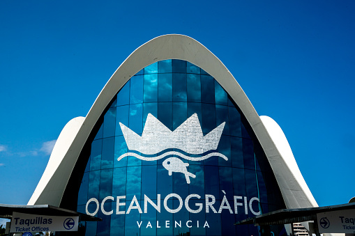 Entrance of Oceanografic Valencia with his logo and interesting building at the sunny day with crystal clear blue sky