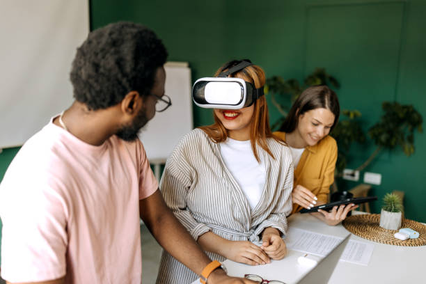 istock Young colleagues testing vr goggles at the office 1598671140