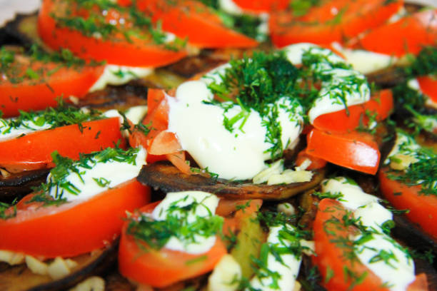 istock Fried eggplants and fresh tomato with souce and herbs 1598672224