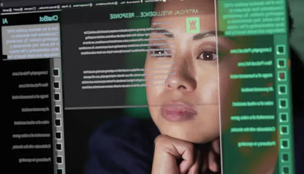 Stock image showing an Asian woman studying a see through screen which is producing lines of AI generated text. A ChatBot similar to A.I. is being read attentively by this woman.