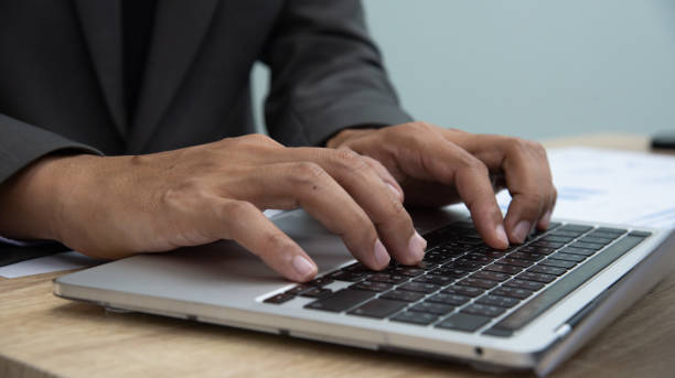 istock Businessman sign a payment check at the table and working on documents in the office room. Businessman working with computer notebook. 1598680360