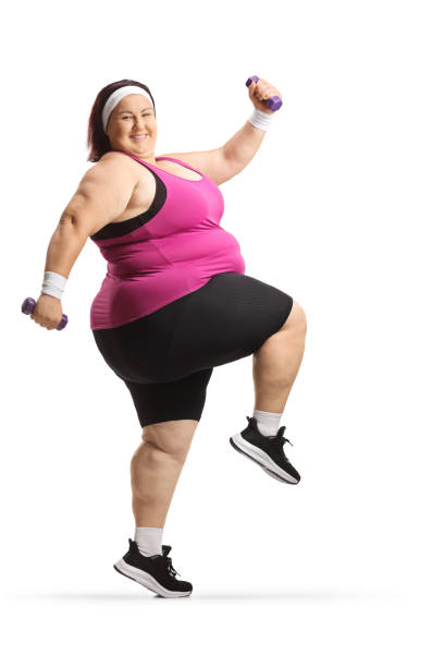 istock Cheerful overweight woman exercising with small weights 1598683898