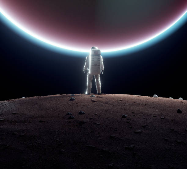 istock Astronaut standing on a planet and looks to the moon. 1598689166