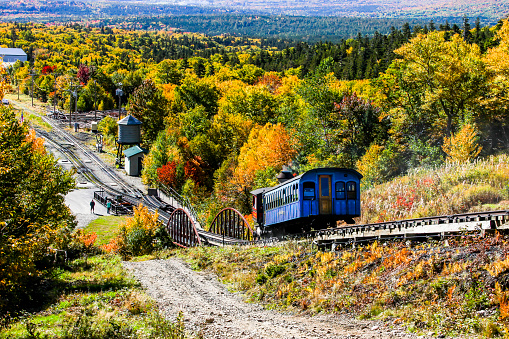 BASE STATION ROAD, NEW HAMPSHIRE, USA - OCTOBER 2, 2022: Cog railway  steam train is returning from Mt. Washingtot tour with tourist