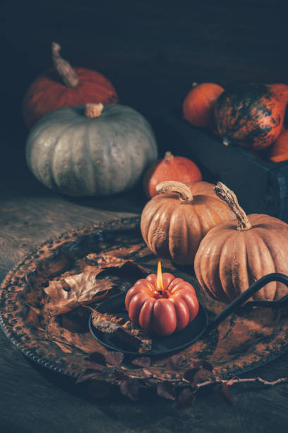istock Autumn or fall harvest concept with pumpkins and candles 1598703686