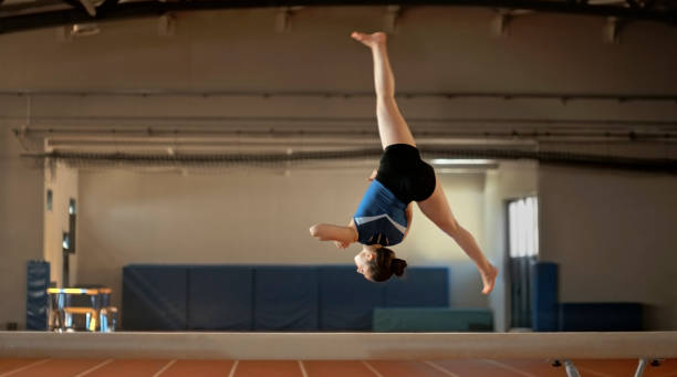 istock Gymnast woman practising on balance beam 1598710877