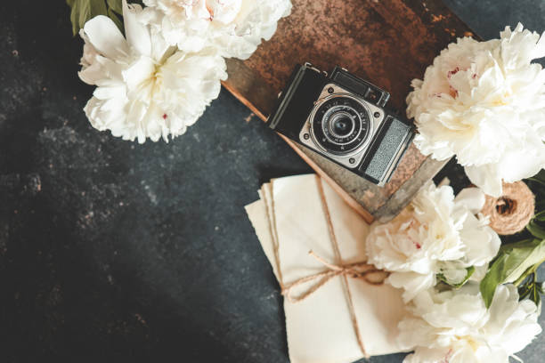istock Summer background, flat lay layout, peonies and retro camera 1598713016