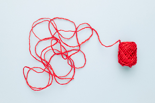 Red jute rope with a complicated end of rope, unravels the confused rope
