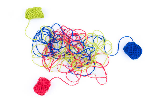 Tangled color threads at the end of lines with thread balls, on white background, confused problem with roots of cause, psychotherapy