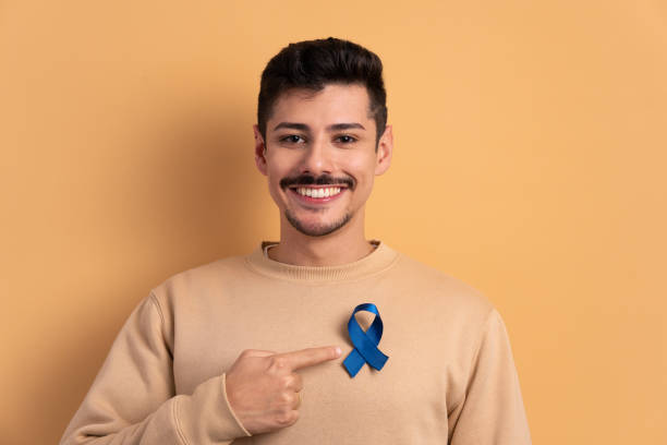 istock happy man showing blue ribbon 1598753440