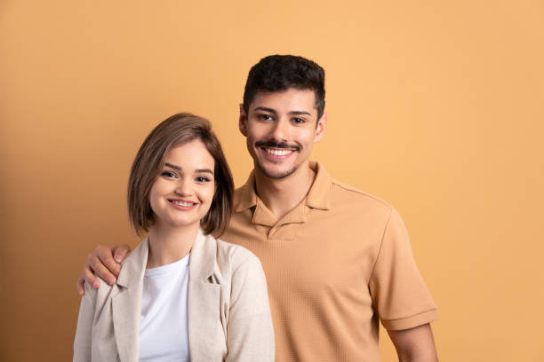 istock couple smiling and looking at camera 1598753776