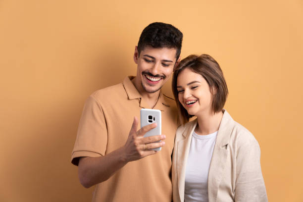 istock couple looking at mobile cell phone 1598753782