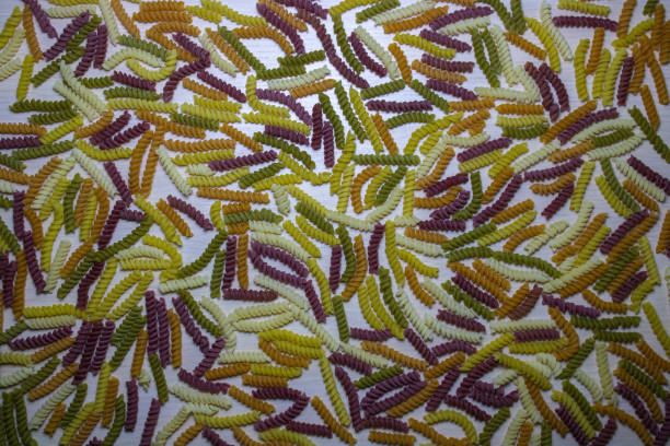 istock Colored pasta texture on a light wooden background. 1598765081